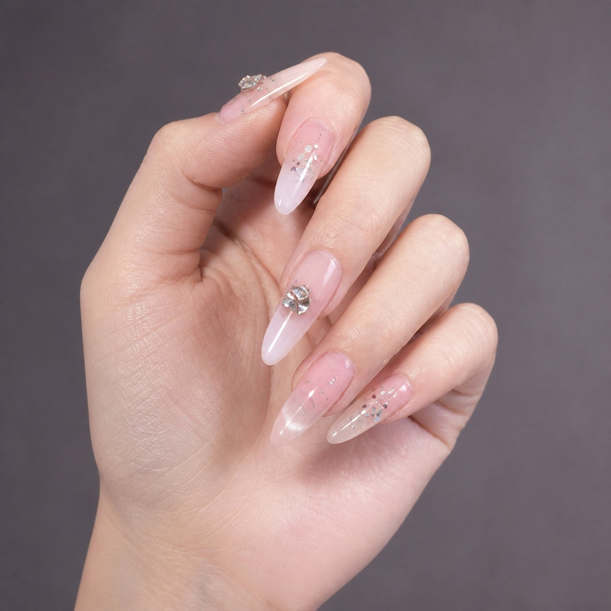 Pink Crystal Drop press-on nails on hand