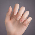 Rosé Petal Charm press-on nails on hand