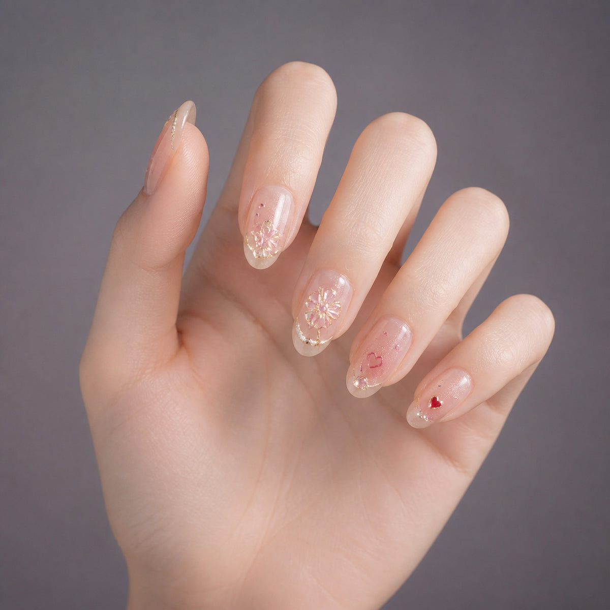 Rosé Petal Charm press-on nails on hand