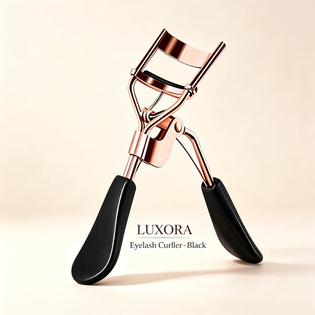 Black eyelash curler with rose gold-tone frame