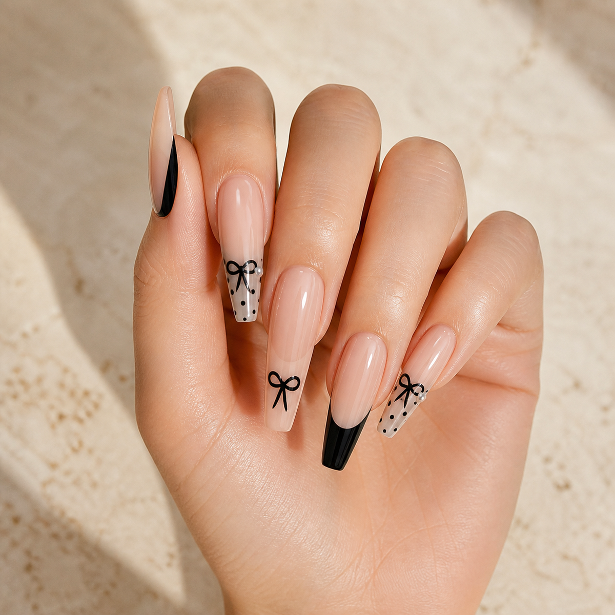 Noir Ballet Bow press-on nails on hand