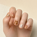 Puppy Plaid press-on nails on hand