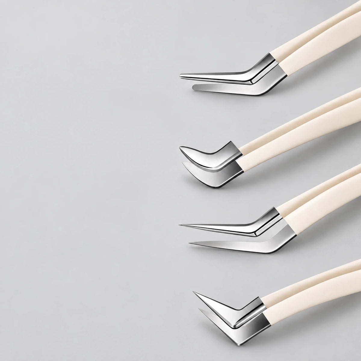 Four ivory-handled precision lash tweezer tips