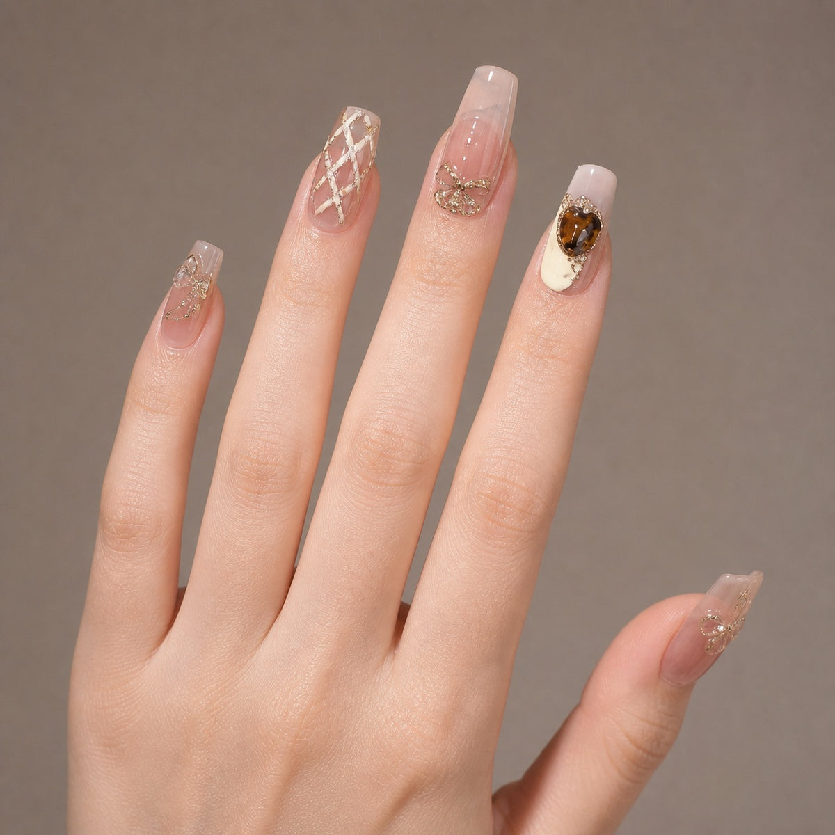 Golden Tea Jewel press-on nails on hand